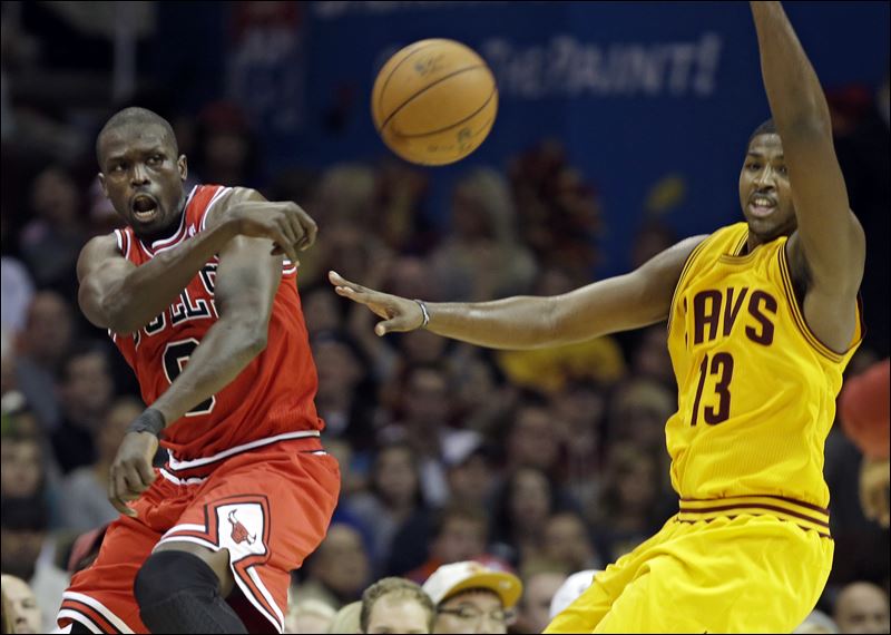 Deng, left, passes around Cleveland's Tristan Thompson