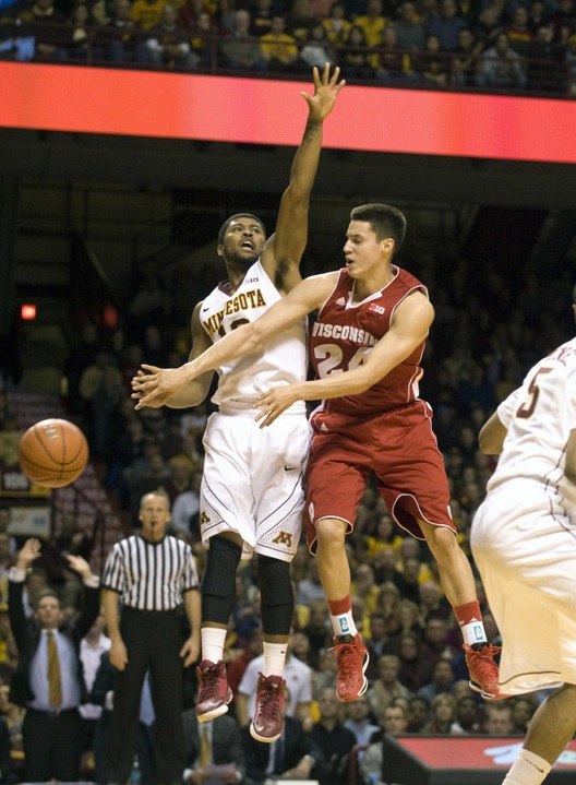 Guard Bronson Koenig (24) passes around Minnesota Gophers guard Maverick Ahanmisi (13) in the first half. Marilyn Indahl-USA TODAY Sports