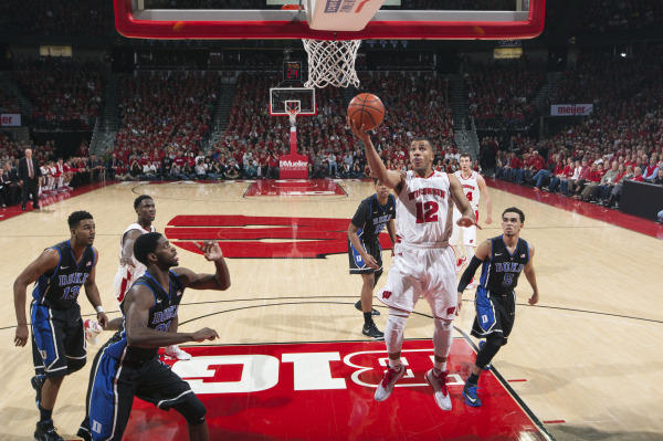 Wisconsin PG Traevon Jackson (12) goes up for a layup amongst four Duke defenders. PHOTO: David Stluka