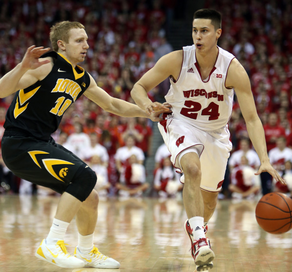 Wisconsin's Bronson Koenig (24) brings the ball down the floor as Iowa Hawkeyes guard Mike Gesell (10) defends. PHOTO: Mary Langenfeld, USA TODAY