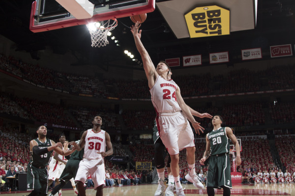 Bronson Koenig (24) reaches for the ball during the Badgers' 68-61 win over Michigan State at the Kohl Center. PHOTO: David Stluka