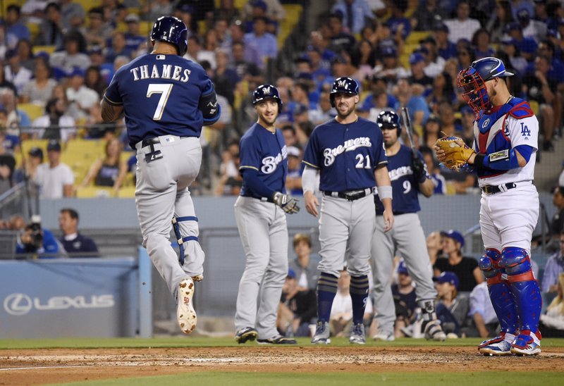 Thames goes deep, Yelich extends hit streak as Brewers down Dodgers