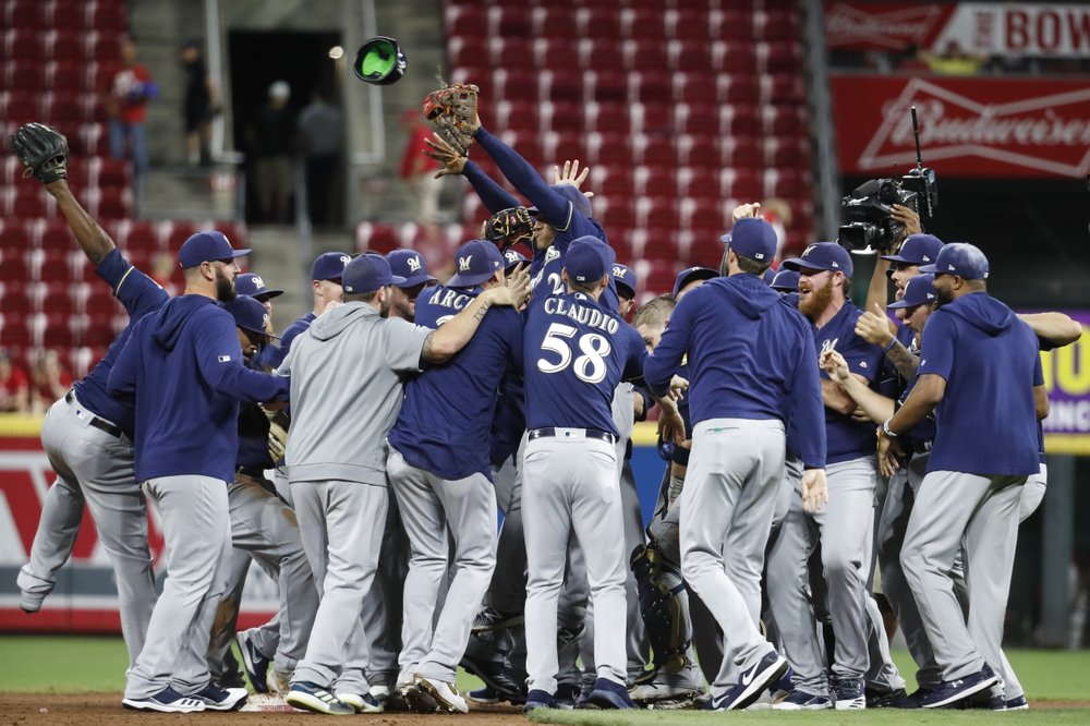 Surging Brewers clinch playoff berth with 9-2 win over Reds