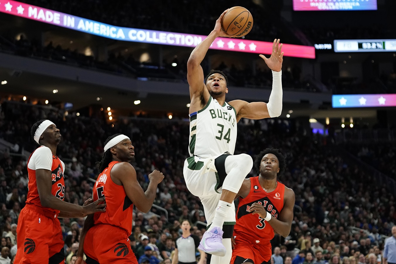 Antetokounmpo triple double leads NBA-leading Bucks past Raptors